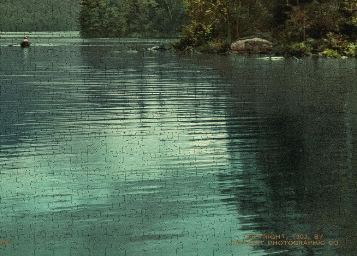 Adirondack Blue Mountain Landscape puzzle: shoreline reflections and printed credit