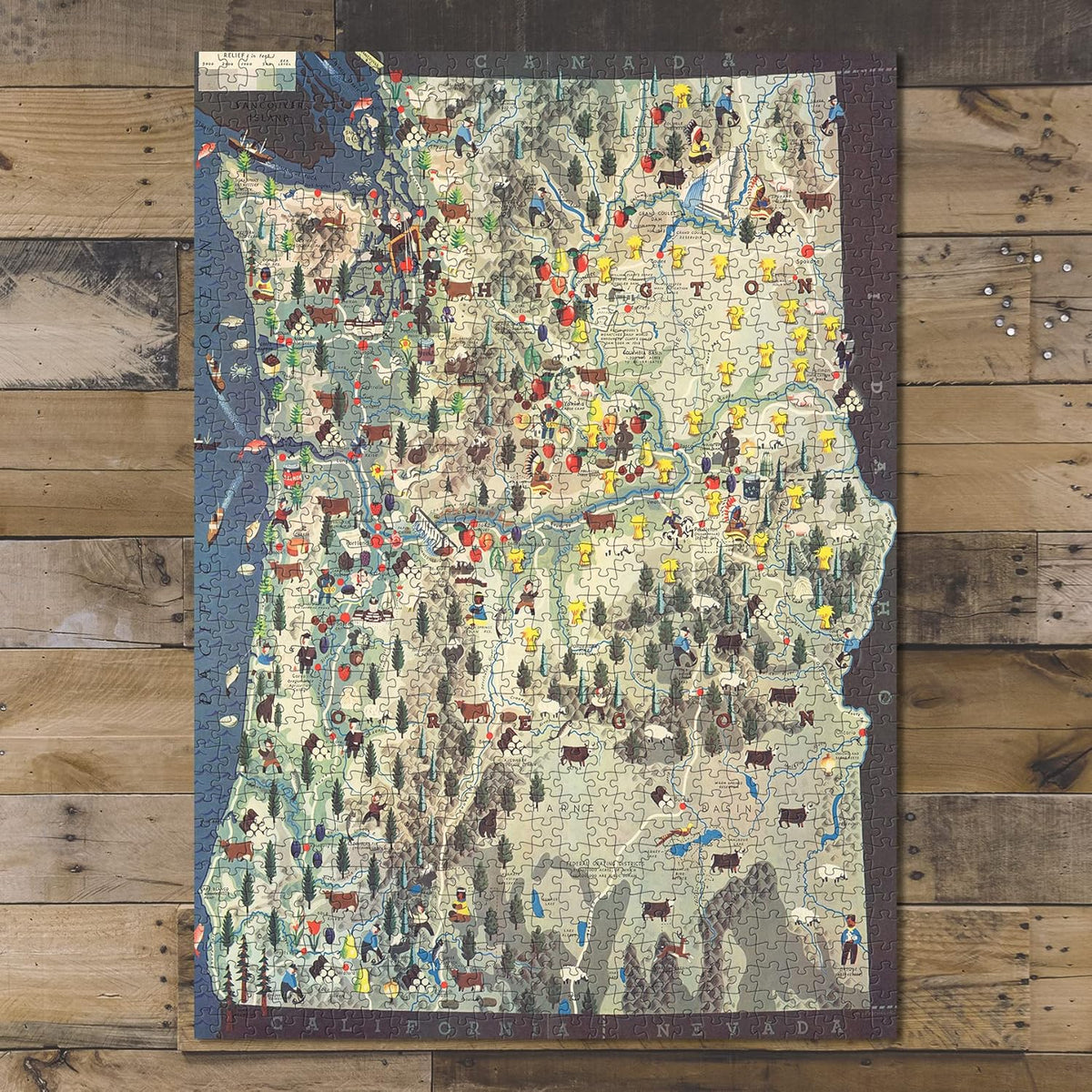 Pacific Northwest Pictorial Map puzzle: completed puzzle on wooden tabletop