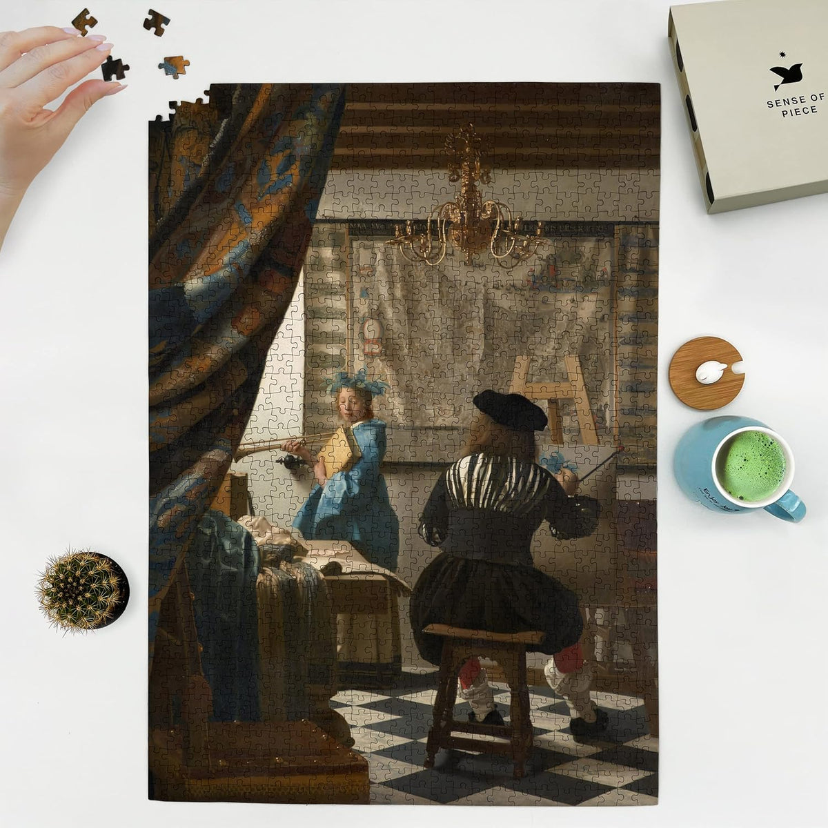 The Art of Painting by Vermeer puzzle: puzzle and box on white tabletop